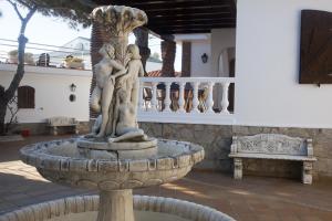 a fountain in the courtyard of a house at Hostal Mar de Frente in Los Caños de Meca