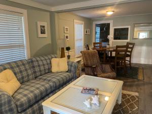 a living room with a couch and a table at 3BR/3BA Charming Key West Style Home in Downtown Saint Augustine in St. Augustine