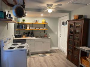 a kitchen with a stove and a sink at 3BR/3BA Charming Key West Style Home in Downtown Saint Augustine in Saint Augustine