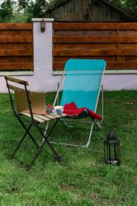 a chair with a laptop sitting in the grass at Nomad Sud Studios in Town Center in Cahul