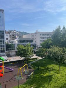 een park met een speeltuin in een stad bij Vertu No1-Apartment in hearth of Sarajevo in Sarajevo