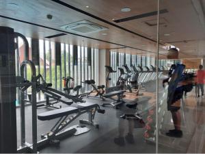 a gym with a bunch of tread machines in it at Mesatierra Garden Residences - Condo in Davao City
