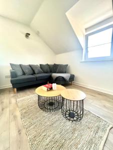 a living room with a couch and a table at Cosy apartment in town centre in Finedon