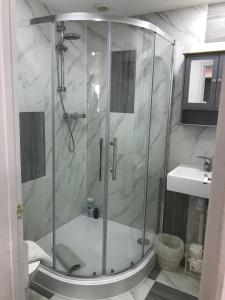 a bathroom with a shower and a sink at Annexe in lymington with private use of hot tub in Everton