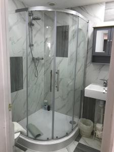 a bathroom with a shower and a sink at Annexe in lymington with private use of hot tub in Everton +15 photos