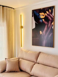 a couch in a living room with a picture on the wall at Apartamento Boutique Beluga in Garrucha