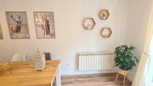 a dining room with a table and some pictures on the wall at VUT Sierra Pambley in Villablino