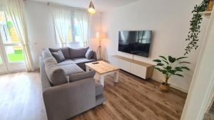 a living room with a couch and a flat screen tv at VUT Sierra Pambley in Villablino