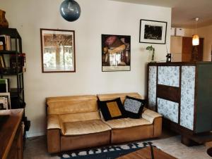Una sala de estar con un sofá de cuero marrón. en Relax fra le colline di Verona, en Verona