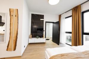 a bedroom with a bed and a living room at Spichlerz Malbork in Malbork