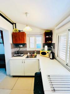 a kitchen with a sink and a microwave at КВАРТИРА ВОЗЛЕ МОРЯ! in Haifa