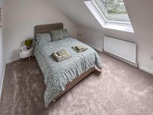 a bedroom with a bed with a black and white comforter at No, 3 Rabbit Warren-uk44299 in Lenwade