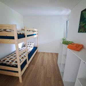 a room with two bunk beds and a desk at Ferienwohnung Muota in Muotathal