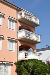 a building with a balcony on the side of it at Apartments Lavanda in Crikvenica