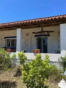 an outside view of a house with a porch at Cozy Corfu Bungalow 5 minutes to Aqualand in Corfu