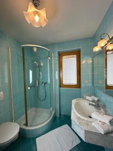 a blue bathroom with a tub and a sink at Residence Aster in Solda