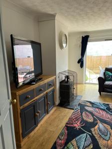 a living room with a flat screen tv on a dresser at Home in Buckland Brewer near Bideford in Bideford