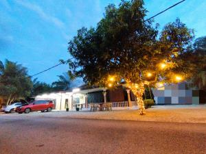 a tree with lights in front of a building at Basrie Villa Pagoh - Mini Cinema , Private Pool , Wi-Fi , NetFlix in Muar