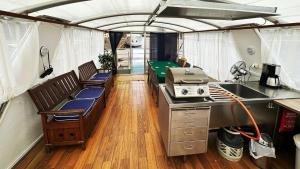 a kitchen and living room in an rv at Houseboat Crescendo, a Floating Experience in Oulu
