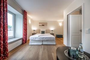 a bedroom with a bed and a large window at Die LÜ - Lüttelforster Mühle in Schwalmtal