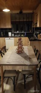 a wooden table with a christmas tree on top of it at ÇAYKARA-NANAGA 1883 Four bedroom villa in Çaykara