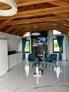 a living room with two chairs and a table at Casa moderna in Sinteu - intersectia intre modern si linistea naturii in Huta Voivozi