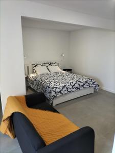 a bedroom with a bed and a couch at Sun Hill Apartment in Santa Cruz