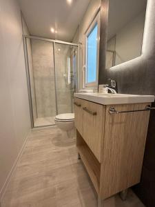 a bathroom with a sink and a toilet and a shower at Camping I Melograni in Marina di Bibbona