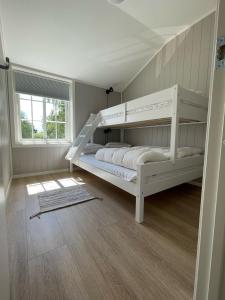 a bedroom with two bunk beds and a window at Vestby Park in Vestby