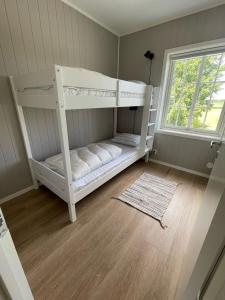 a white bunk bed in a room with a window at Vestby Park in Vestby