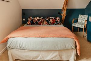 Tempat tidur dalam kamar di Gîtes de charme pour 2 au calme aux portes de Bayeux by Le Clos Poulain