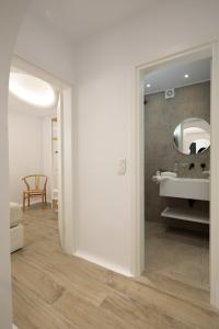 a bathroom with a sink and a mirror at WOW Panoramic View Deluxe Villas in Agkidia