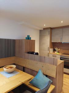 a kitchen with a wooden table with a bowl on it at Ferienwohnung CASADA im Hotel Casada in Galtür