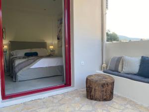 a mirror in a room with a bed and a table at Cozy 2-bdrm-house with garden and view, Katouna Home III in Katouna