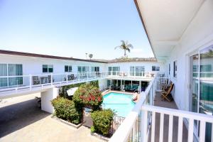 an indoor balcony of a house with a swimming pool at Capri Laguna on the Beach - A Boutique Hotel in Laguna Beach
