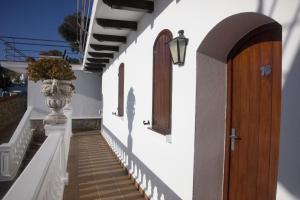 a hallway with a wooden door and stairs at Hostal Mar de Frente in Los Caños de Meca