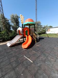 a childrens playground with a slide in a park at Апартамент Попов in Sunny Beach