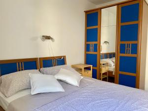 a bedroom with a bed and a mirror at 2 bedrooms apartment with sea view in Baška Voda