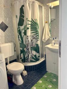 a bathroom with a toilet and a shower curtain at 2 bedrooms apartment with sea view in Baška Voda