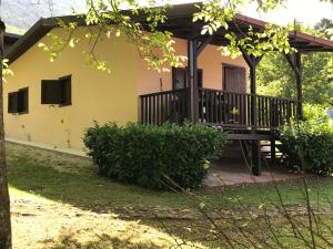 a house with a porch and a deck at Agriturismo Fattoria Antica Forconia in LʼAquila