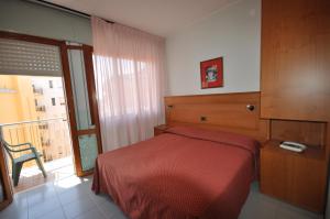 Postel nebo postele na pokoji v ubytování Hotel Real