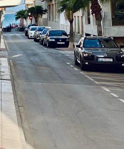a row of cars parked on the side of a street at Paradise Sol Apartamento en Los Alcázares in Los Alcázares