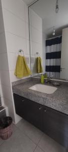 a bathroom with a sink and a mirror at Iquique, ED. MATIZ CAVANCHA in Iquique