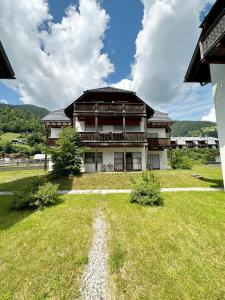 a large house with a grass yard in front of it at Apartment MEISE in Bad Kleinkirchheim