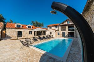 a pool in front of a house at Luxury Villa Cortile in Benkovac