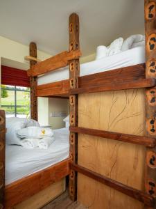 two bunk beds in a room with wood at The Eagle's Nest in Boat of Garten