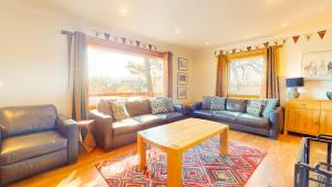 a living room with two couches and a table at The Shieling in Aviemore