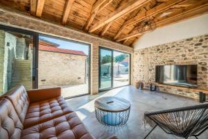 a living room with a couch and a tv at Luxury Villa Cortile in Benkovac