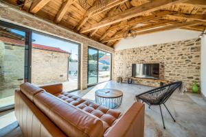 a living room with a couch and a fireplace at Luxury Villa Cortile in Benkovac