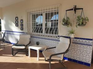 a room with two chairs and a table and a window at R Gem by the Sea in Vélez-Málaga